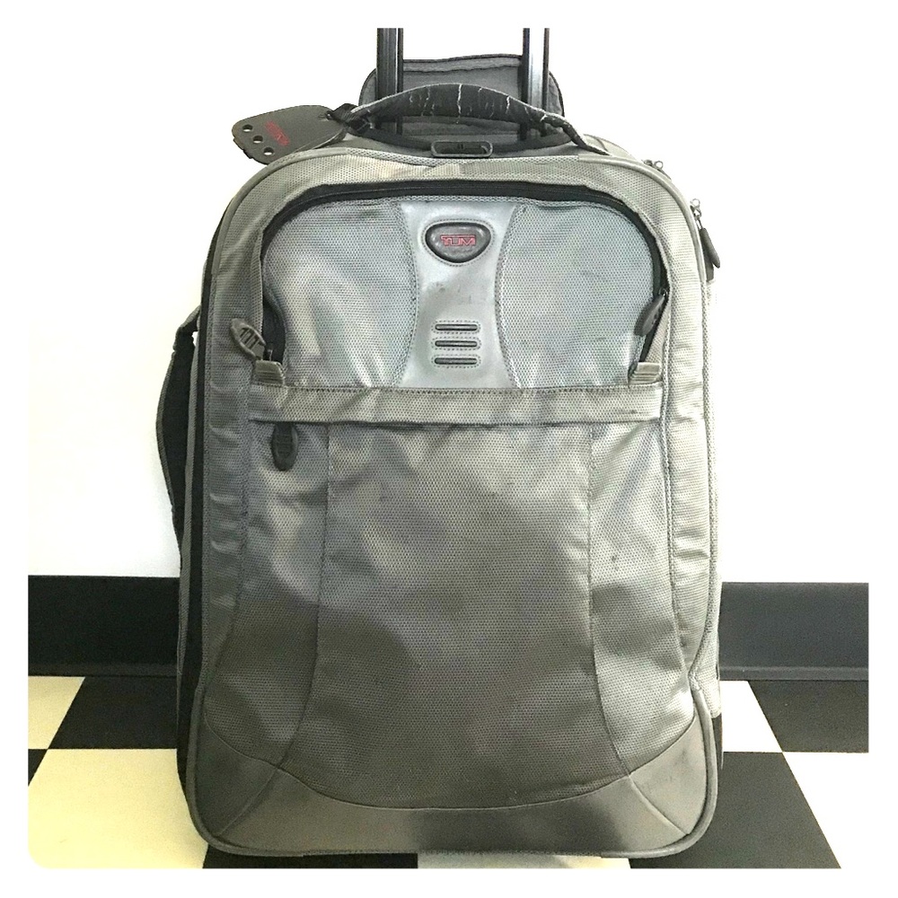 TUMI gray carry-on roller suitcase